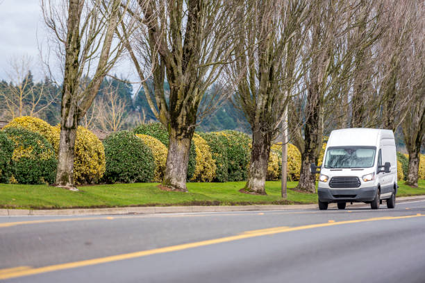 istock Small compact commercial transportation mini van driving on the straight local road 1160472033