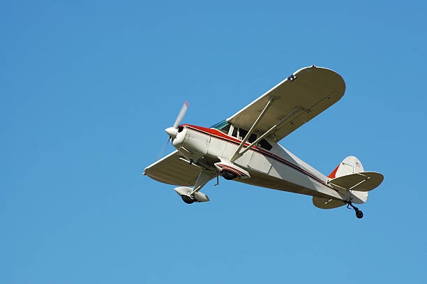 private airplane Fairchild M62A flying in clear blue sky Small private airplane against blue sky. Built in the 1940s. Fairchild M-62A. propeller airplane stock pictures, royalty-free photos & images