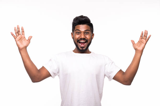 istock I won. Happy young indian man gesturing and smiling while standing against white background 1160473931