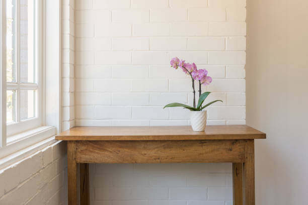 istock Purple moth orchid on wooden side table 1160474267