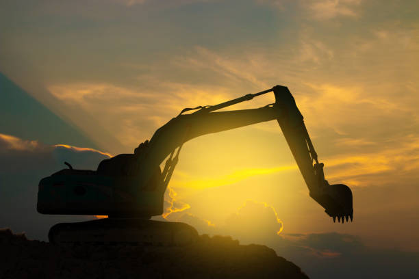 istock Excavators are working hard on sunset sky. 1160475488