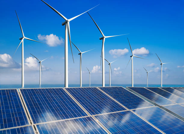 istock Solar panel and wind turbine farm clean energy. 1160478097