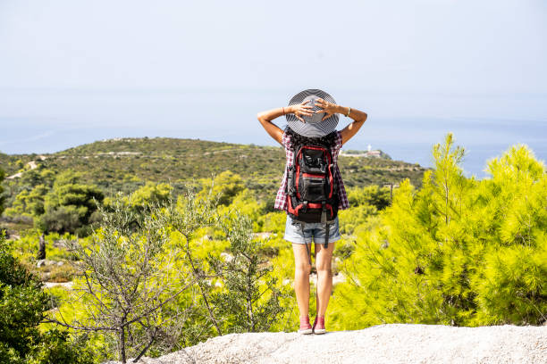 istock Female backpacker standing on top mountain and looking at view 1160478783