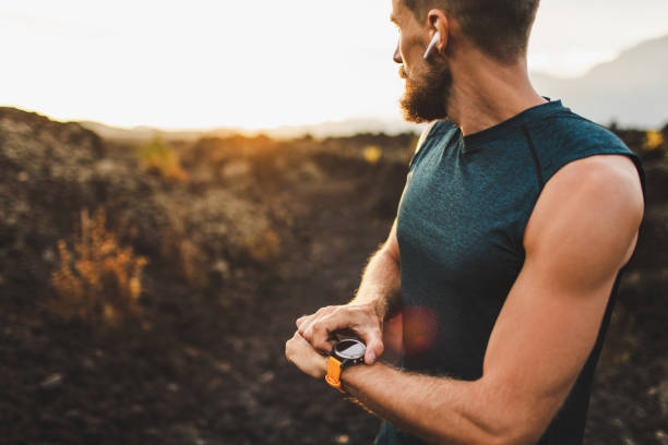 istock Athletic runner start training on fitness tracker or smart watch and looking forward on horizon. Trail running and active lifestyle concept. 1160478814