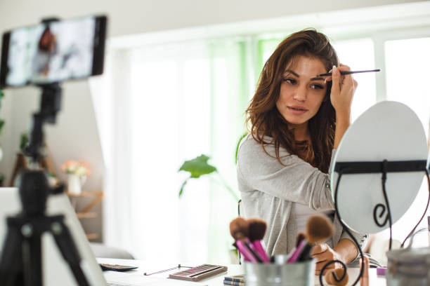istock Make-up blogger applying make-up on live stream 1160478927