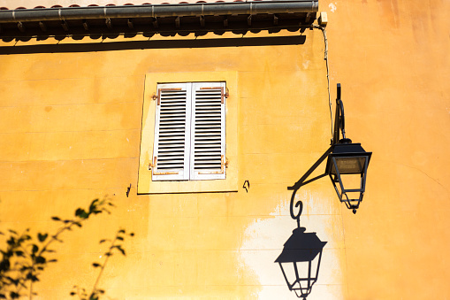 Marseille Architecture: Beautiful Sunlit Yellow Building, Street Lamp in early morning. Shot in Le Panier district.