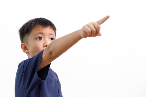 istock Little boy standing and pointing on something 1160493154