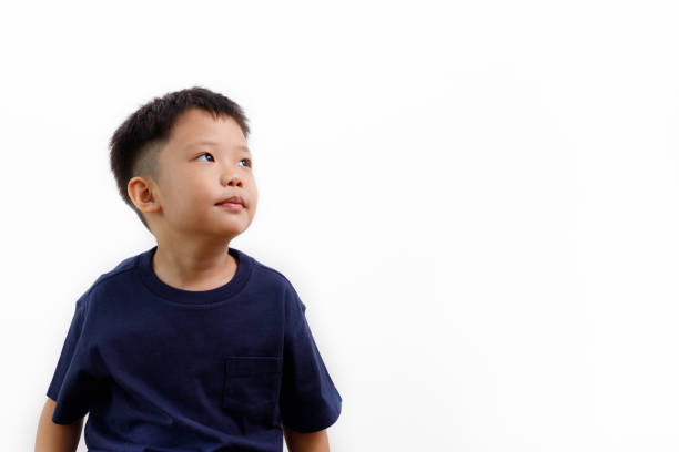 istock Asian boy looking away isolated on white background 1160494776