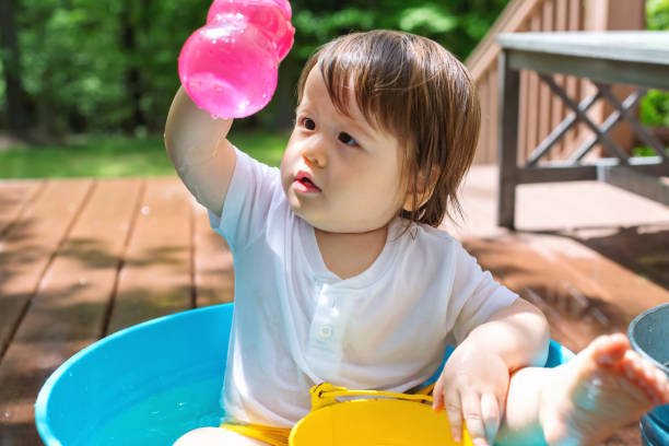 istock Young toddler boy playing with water 1160496420