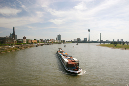 container ship floating on the River Rhine through Dusseldorf