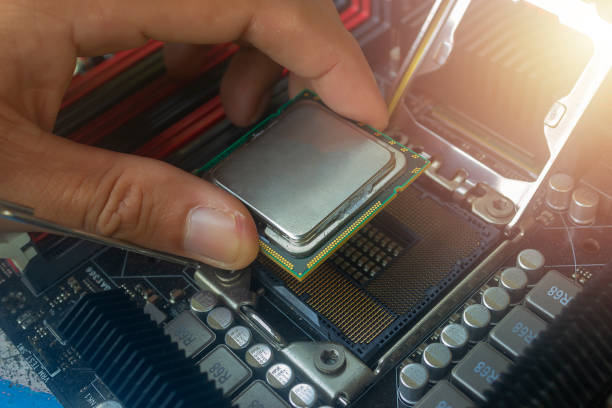istock Close up hand of technician putting CPU on the socket of computer motherboard 1160500098