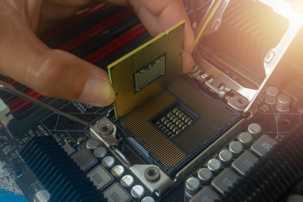 istock Close up hand of technician putting CPU on the socket of computer motherboard 1160500191