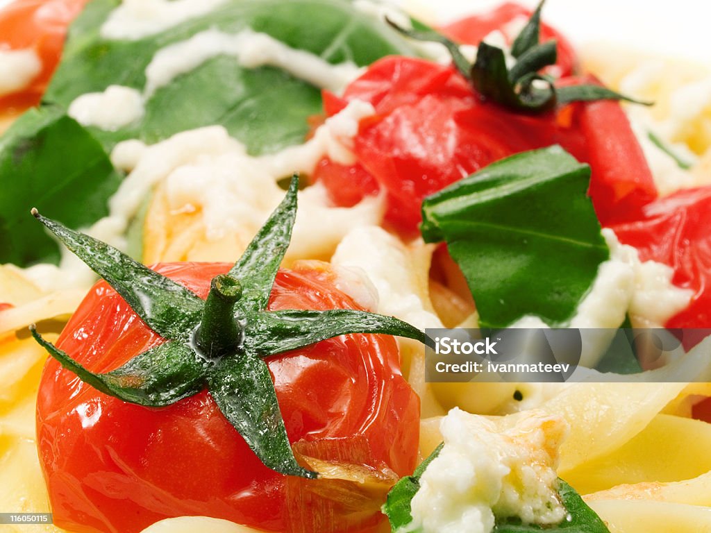 Pasta Collection - Fettucini with tomatoes, basil and mozarella Fettucini prepared with fried cherry tomatoes, basil and mozarella Basil Stock Photo