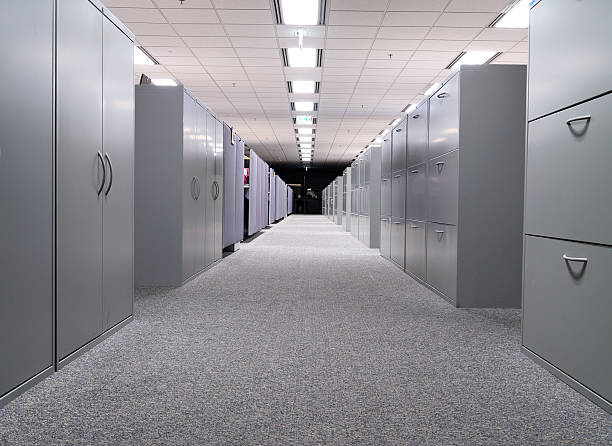 Long hall with grey file cabinets on both sides In the office filing cabinet photos stock pictures, royalty-free photos & images