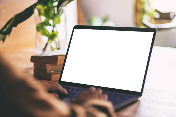 istock a woman using and typing on laptop with blank white desktop screen 1160505872