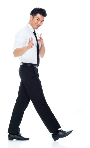 istock Handsome Asian Businessman - side view walking and doing finger gun 1160509065