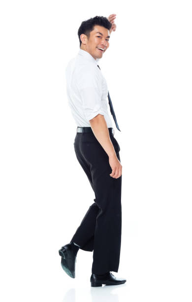 istock Handsome Asian Businessman - walking and waving 1160509090