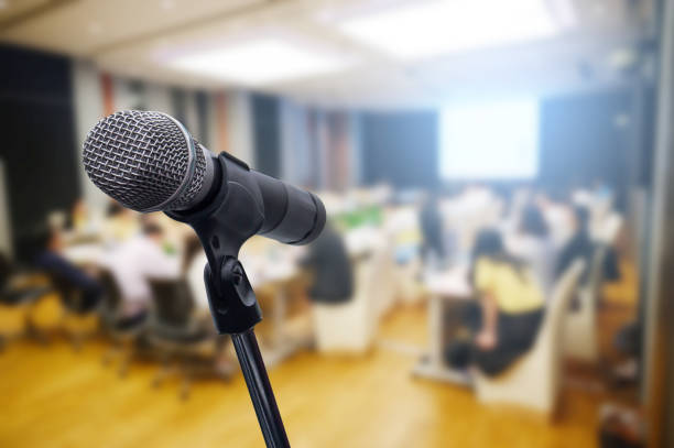 istock Microphone over the blurred business forum Meeting or Conference Training Learning Coaching Room Concept, Blurred background. 1160509111