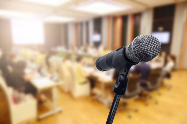 istock Microphone over the blurred business forum Meeting or Conference Training Learning Coaching Room Concept, Blurred background. 1160509130