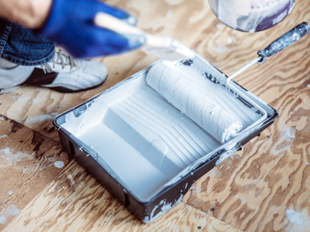 istock Senior man painting apartment interior 1160511543