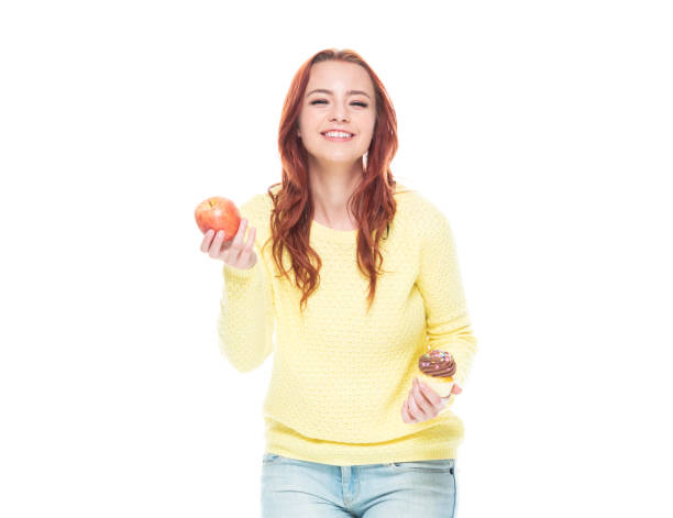 istock Female holding cupcake and apple 1160513367