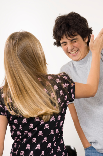 young teen girl slapping a boy face