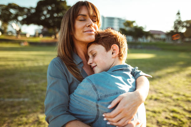 istock teenager embraced with mom consoling her son 1160519376