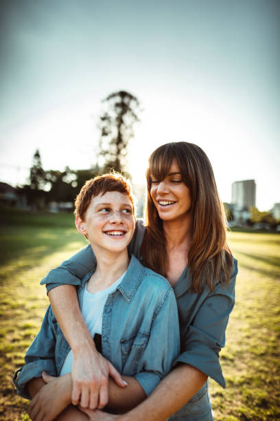 istock teenager embraced with mom consoling her son 1160519449
