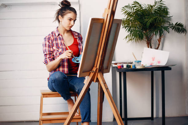 istock Elegant girl draws in an art studio 1160519600