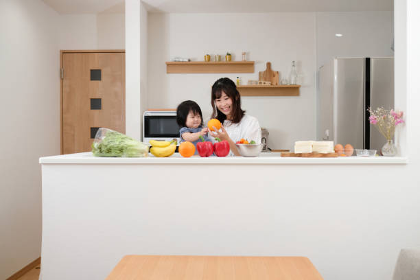 istock Mother preparing for healthy lunch with baby in kitchen 1160520457