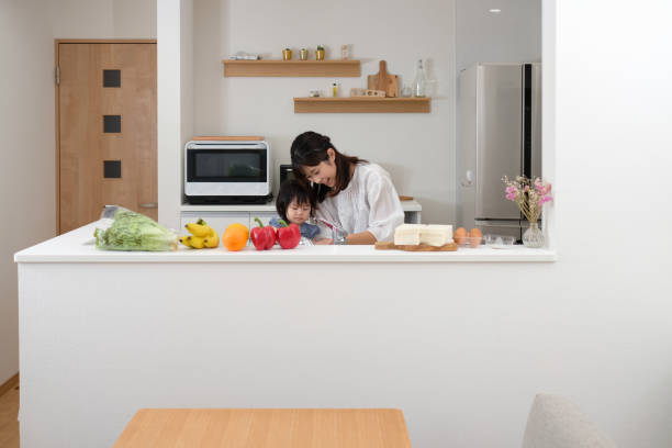 istock Mother preparing for healthy lunch with baby in kitchen 1160520562