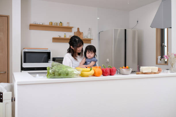 istock Mother preparing for healthy lunch with baby in kitchen 1160520563