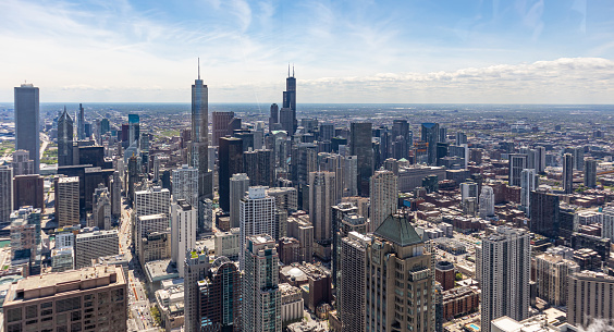 Chicago cityscape aerial view, spring day. High rise buildings, blue cloudy sky background. High angle view from skydeck