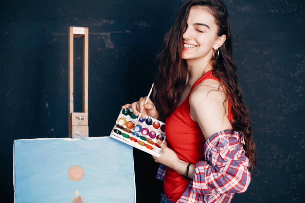 istock Elegant girl draws in an art studio 1160521440