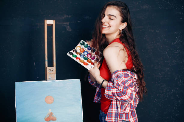 istock Elegant girl draws in an art studio 1160521450
