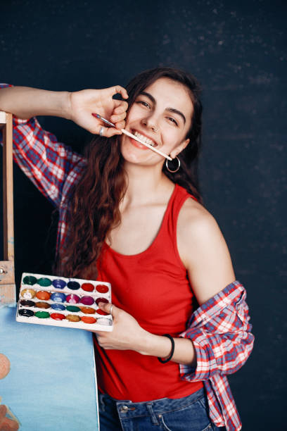 istock Elegant girl draws in an art studio 1160521474