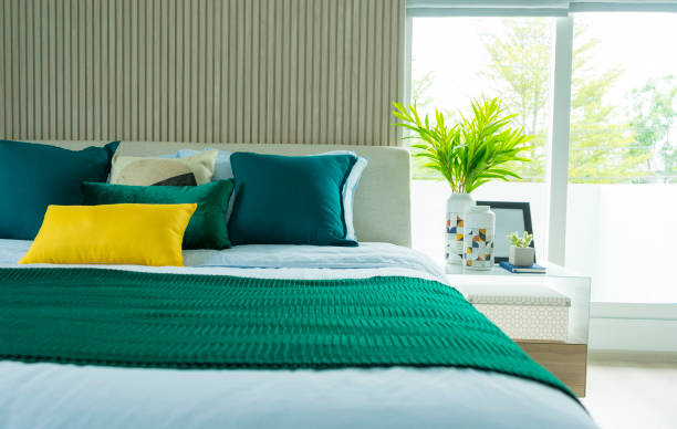 istock modern bedroom interior with green and yellow pillow on it. 1160525176