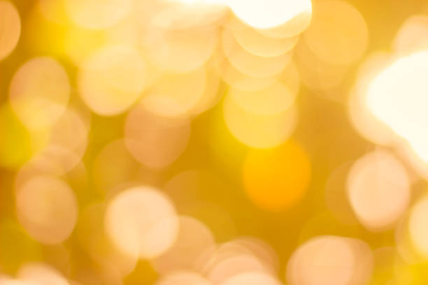 istock Blurred christmas tree lights on background. Design effect focus happy holiday party glow texture white wall bokeh sun sunny star shiny soft plain warm flare blur light orange new year. 1160527783