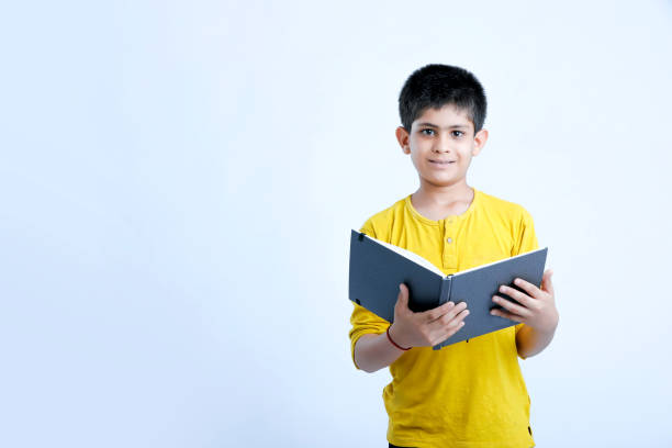 istock young indian cute child with book 1160527868