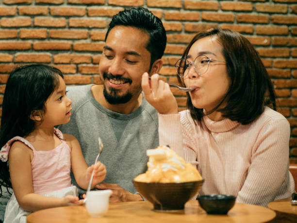 istock Asian family having dinner together with dessert. 1160527986