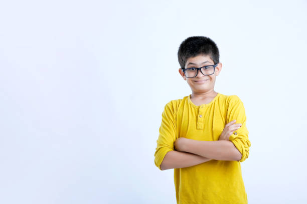 joven niño indio lindo de pie sobre el fondo blanco - child asian and indian ethnicities facial expression asia fotografías e imágenes de stock