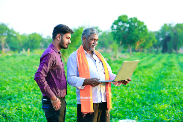 istock indian agronomist with farmer at field 1160529554