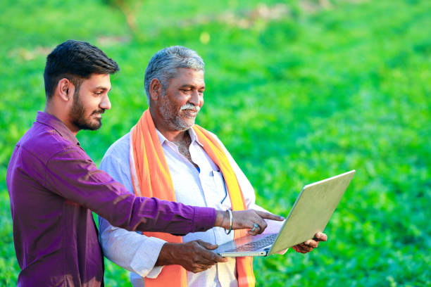 indian agronomist with farmer at field indian agronomist with farmer at field human hand traditional culture india ethnic stock pictures, royalty-free photos & images