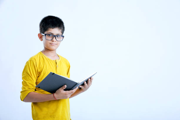 istock young indian cute child with book 1160530133