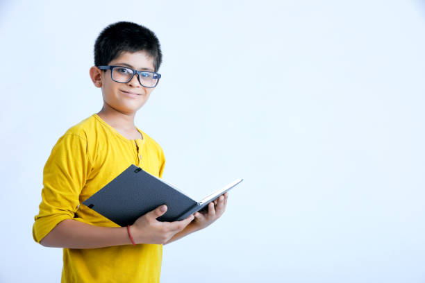 istock young indian cute child with book 1160530171