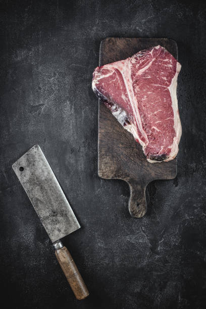 istock Dry Aged Beef Raw T-bone Steak on Vintage Cutting Board 1160530209