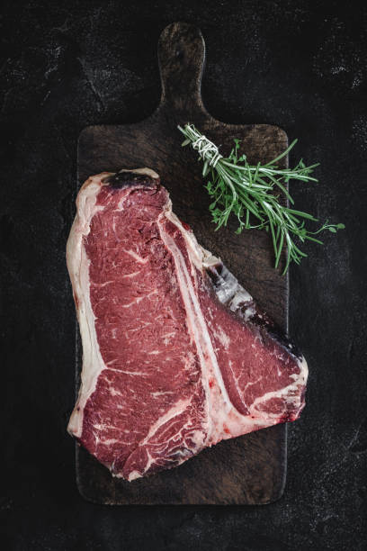 istock Dry Aged Beef Raw T-bone Steak on Vintage Cutting Board 1160530210