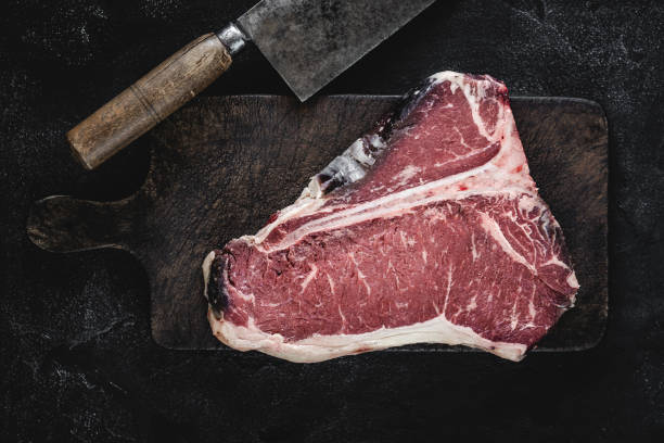 istock Dry Aged Beef Raw T-bone Steak on Vintage Cutting Board 1160530211