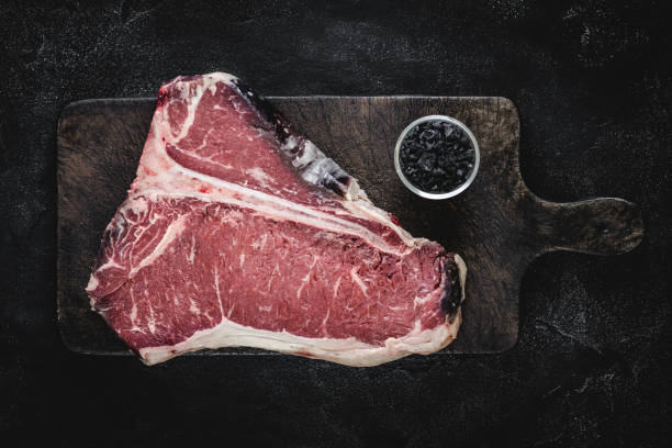 istock Dry Aged Beef Raw T-bone Steak on Vintage Cutting Board 1160530213