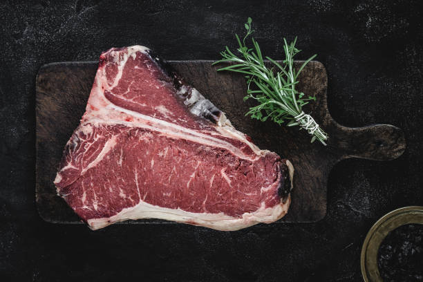 istock Dry Aged Beef Raw T-bone Steak on Vintage Cutting Board 1160530215